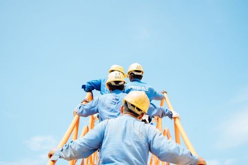 construction workers walking up a stairway on the job site 