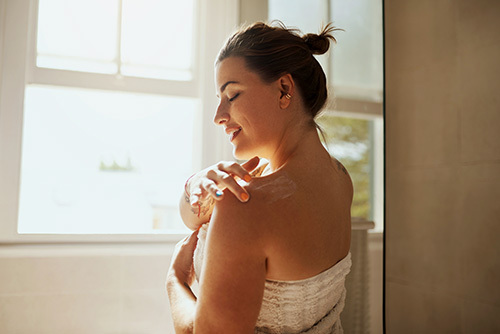 Woman applying a lighter moisturizer during the Spring months