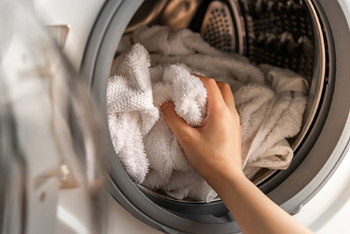 Putting towels in the washer