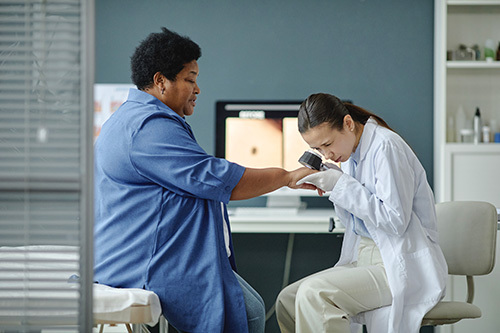 Dermatologist performing a skin check on a patient 
